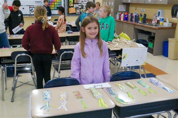 girl selling bookmarks on her desk